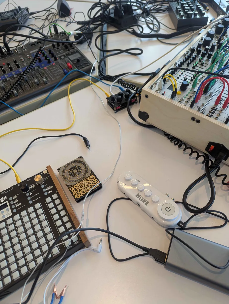 Synth gear and modular patch cables on a table